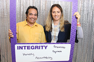 A man and a woman stand inside a frame that reads 'South Metropolitan Health Service: Integrity'. A handwritten message on the board reads 'Honesty, responsible, equitable, accountability.'