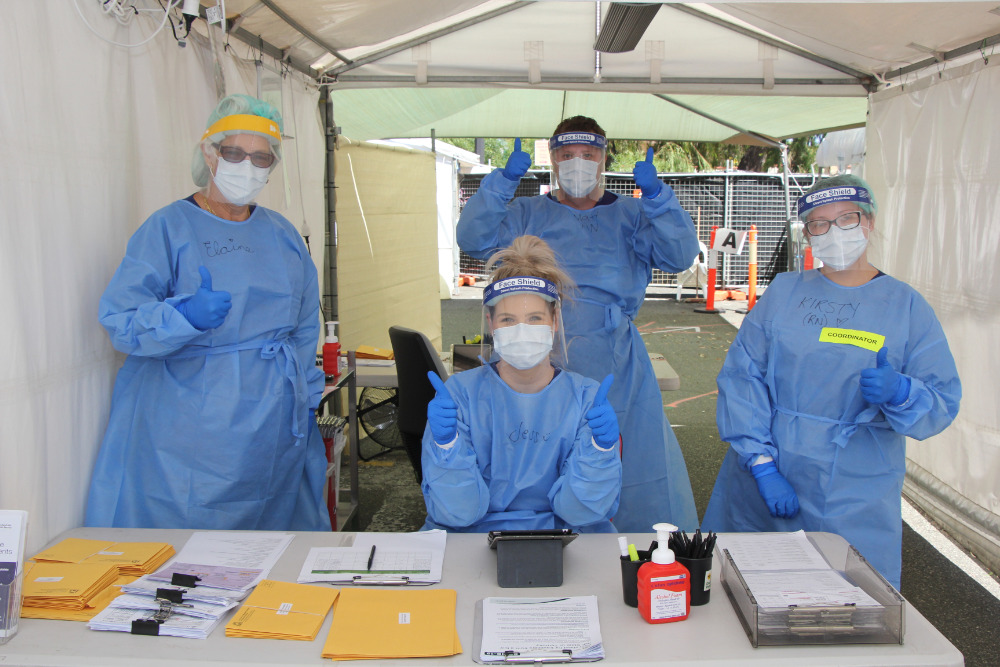 Health officers wearing PPE at COVID testing clinic