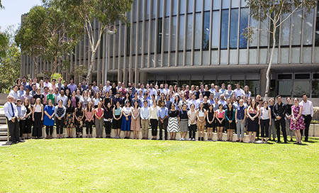 118 new medical graduates who joined South Metropolitan Health Service stand outside in an amphitheatre style garden.