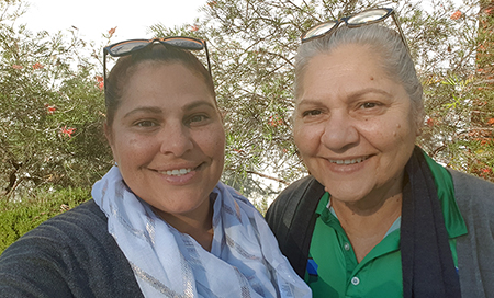 A close up photograph of two female Aboriginal Health Liaison Officer