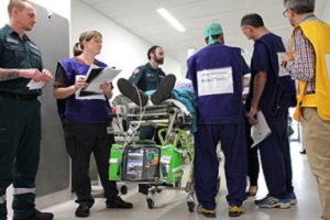 A team of health professionals assessing a 'patient' during a clinical simulation