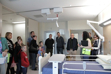 A tour group inside a patient room at FSH