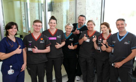 Group of medical staff in the Children's Emergency Department with their thumbs up