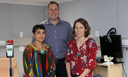 A man and two women standing in a treatment room