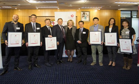 Group of people holding framed certificates